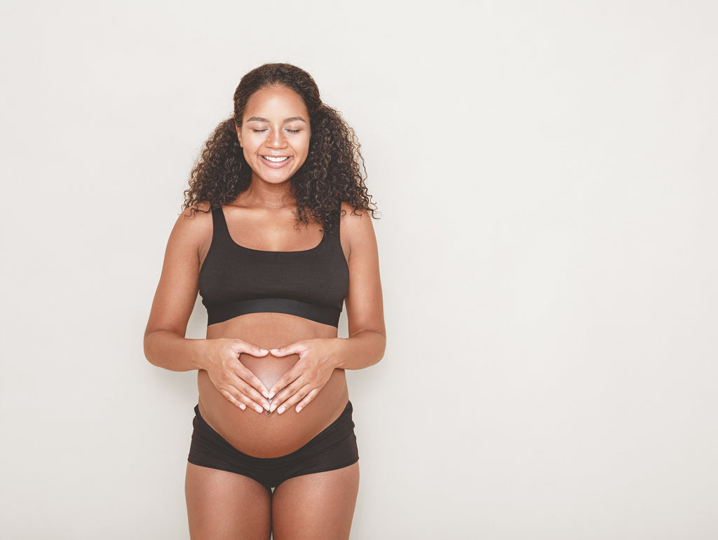 prenatal wellness happy pregnant woman african american pregnant woman